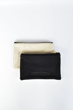 The limited-edition Marin pouch combines some of our favorite things - design, versatility, function and of course, beautiful materials. The pouch can be used as a clutch on its own or coordinates seamlessly with any one of our bags to keep things tidy and organized. Every pouch is handmade in the USA and finished with a brass zipper pull and our signature leather logo patch. Front: Black Cotton CanvasBack: Off White Suede Content:- Suede and Cotton Canvas- Made in the USA- Quantities limited Si Trendy Luxury Pouch Bags, Luxury Women's Pouch With Leather Lining, Minimalist Pouch Clutch For Everyday Use, Everyday Pouch Clutch, Everyday Rectangular Clutch With Zipper Pouch, Minimalist Everyday Pouch Clutch, Everyday Pouch Pencil Case, Everyday Zipper Pouch Cosmetic Clutch, Everyday Rectangular Pouch With Flat Pocket