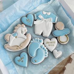 decorated cookies in the shape of baby items