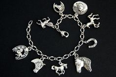 A collection of silver plated horse and horse lover themed charms have been dispersed around a shimmering silver plated bracelet chain in this handmade charm bracelet. This horse lover charm bracelet is then completed with a lobster clasp and a 1/2 inch of chain at the end for adjustable sizing. Charms in this bracelet include a rearing horse charm, running horse charm, trotting horse charm, three horse profile charms, two horse with horseshoe charms, and a horseshoe charm. ● Sizing ● To determi Metal Horse Design Jewelry Gift, Silver Horse Design Bracelet Gift, Silver Horse Design Bracelet Jewelry, Silver Bracelet With Horse Design For Gift, Silver Horse Design Jewelry Bracelet, Horse Charm Bracelet, Trotting Horse, Medieval Horse, Lover Bracelet