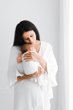 a woman holding a baby in her arms