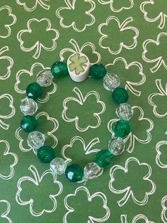 This is a shamrock bracelet. It would make a cute gift for a little girl for St Patrick's Day. It would make a cute addition to a little girl's St Patrick's Day outfit. It has a white shamrock fimo clay bead in the middle. It has green and clear 8mm faceted beads. It was made with .8mm sturdy stretch string. I tie it several times to prevent breakage. It fits girls ages 4-8. It stretches to fit on the wrist. All items are ready to be shipped I do combined shipping. Items ship in 2-5 business day St Patricks Toddler, Shamrock Bracelet, Brother Sister Gifts, Bracelets For Kids, Bracelets For Girls, Boys Bracelets, Toddler Bracelet, Candy Bracelet, St Patrick's Day Outfit