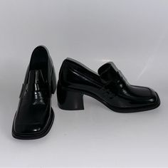 Elevate Your Footwear Game With These Jeffrey Campbell Ecole Slip-On Loafers. The Squared Toe And Block Heel Provide A Chic And Trendy Touch, While The Black Leather Material Gives It A Versatile And Timeless Look. This Pair Is Perfect For Any Occasion, Whether It's A Formal Event Or A Casual Day Out. The Slip-On Closure Ensures A Comfortable Fit, Making It Easy To Wear For Extended Periods. These Loafers Are Available In Us Shoe Size 6 And Are Suitable For Regular Size Types. The Leather Lining Black Slip-on Oxfords With Pointed Toe, Black Square Toe Leather Shoes For Office, Black Closed Toe Dress Shoes For Office, Black Platform High Heel Loafers, Black Patent Leather Loafers With Square Toe, Black Square Toe Oxfords For Business, Formal Patent Leather Platform Loafers With Block Heel, Black High-heeled Platform Loafers, Office Heels With Square Toe