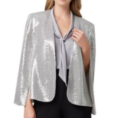 Nwt Tahari Asl Women Metallic Sequined Cape Blazer Sequin-Covered Jacket With Side Pockets And Hook & Eye Closure. Open Front Long Cape Sleeves Dry Clean Material: 91% Nylon/6% Elastane/3% Other Fibers Size Small Color Silver Gold New With Tag Dry Clean ` Silver Blazer For Night Out, Elegant Silver Blazer For Night Out, Elegant Silver Blazer For Evening, Elegant Silver Evening Blazer, Elegant Silver Winter Blazer, Silver Glamorous Formal Outerwear, Glamorous Silver Formal Outerwear, Elegant Silver Sequined Outerwear, Silver Spring Party Blazer