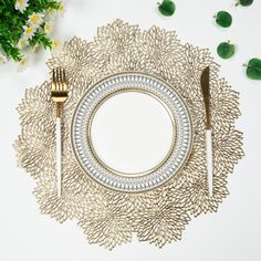 a place setting with silverware and flowers