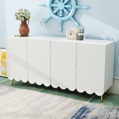 a white radiator sitting on top of a rug next to a blue wall