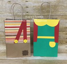 two paper bags with the number four on them, one has a green and red elf costume