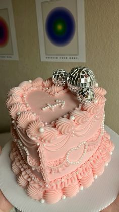 a heart shaped cake with disco balls on top