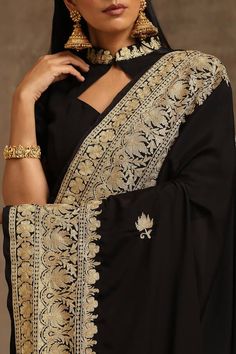 Black saree, accentuated with contrast kashmiri tilla embroidery. Paired with a front cut-out blouse with placement kashmiri tilla embroidery.
Components: 2
Pattern: Embroidery
Type Of Work: Kashmiri Tilla
Neckline: High Neck
Sleeve Type: Half Sleeves
Fabric: Crepe, Georgette, Lining: Cotton
Color: Black
Other Details: 

Blouse Length: 16 inches
Approx. product weight: 2 and 1/2 kg
Model height: 5ft 7inches, wearing size S
Inner lining
Occasion: Sangeet - Aza Fashions Elegant Semi-stitched Pre-draped Saree With Embroidered Border, Elegant Fitted Saree With Embroidered Border, Formal Pre-draped Saree With Intricate Embroidery, Formal Unstitched Saree With Intricate Embroidery, Formal Saree With Resham Embroidery For Navratri, Elegant Blouse Piece With Embroidered Border For Eid, Formal Saree With Intricate Embroidery For Eid, Elegant Jamawar Pre-draped Saree For Wedding, Elegant Blouse Piece With Embroidered Border For Festive Season