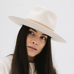 Elevate your style with the Holly Rancher Hat. The semi-tall fedora crown and mid-length upturned brim make this hat the perfect blend of bold and approachable. The hand-sewn suede band adds a touch of sophistication, making it easy to pair with any accessory. A must-have for hat wearers of all levels! brim, ivory, cream, white, fedora, felt, wool, stiff Classic Wide Brim Panama Hat For Fall, Fur Felt Hat With Curved Brim For Spring, Spring Fur Felt Hat With Curved Brim, Spring Brimmed Fur Felt Fedora, Spring Fur Felt Brimmed Hat, Spring Brimmed Fur Felt Hat, Adjustable Flat Crown Panama Hat For Fall, Spring Wide Brim Fur Felt Hat, Western Fur Felt Fedora For Spring