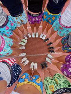 a group of people standing in a circle with their feet together