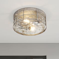 a ceiling light that is hanging from the ceiling in a room with white walls and doors