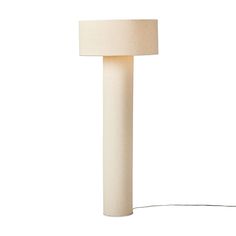 a lamp that is on top of a white surface with a cord attached to it