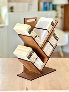 a stack of books sitting on top of a wooden table