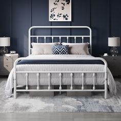 a bedroom with blue walls and white furniture