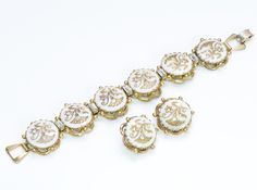 Kramer New York Bracelet Earrings Set. Rare 1950’s Kramer of NY bracelet and earrings set. Gold tone white/gold Victorian style. Approximate Measurements: Bracelet: Length 7.5”, Width 1” Earrings: Diameter 1” Made in: USA Condition: Very Good White Round Clip-on Jewelry, Antique White Bracelet Jewelry, White Antique Bracelet Jewelry, White Antique Bracelet, White Antique Jewelry For Formal Occasions, White Costume Jewelry For Formal Occasions, Victorian White Jewelry For Evening, Antique White Jewelry With Matching Earrings, White Clip-on Jewelry For Anniversary