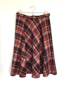 "Vintage Joyce Sportswear plaid full skirt with belt 2 button side closure with pocket Maroon, red, blue, green & cream plaid No size tag- fits like a small- you could re-sew buttons if you want to adjust waist Please check measurements below and compare to a favorite skirt No fiber tag- feels like a wool blend- tag marked dry clean only Tag marked: Int Ladies Garment Workers Union- Union Made ILGWU- Made in USA- Thank you for buying American made apparel Measurements taken while laying flat: Wa Casual A-line Plaid Skirt, Winter Plaid Cotton Skirt, Winter Cotton Plaid Skirt, Plaid A-line Skirt With Lining, Plaid Skirted Bottoms With Lined Skirt, Plaid Full Skirt With Lining, Red Lined Skirt For Fall, Plaid Skirted Bottoms For Fall, Retro Winter Skirt