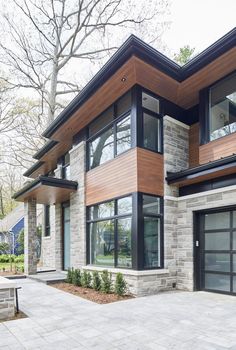 a modern house with two garages and large windows