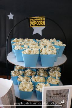 there is a three tiered cake with popcorn on it and stars above the cupcakes