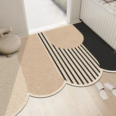 the rugs on the floor are different shapes and sizes, but one is black and white