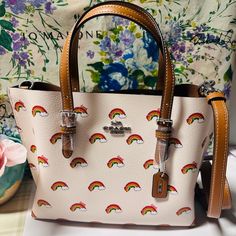 Questions? Leave A Comment Below! Coach Ck373 Mollie Tote 25 Rainbow Print Coated Canvas & Leather Crossbody Bag Product Details Printed Coated Canvas And Smooth Leather Zip-Top Closure, Fabric Lining Side Open Compartments Handles With 4 3/4" Drop Detachable Strap With 22" Drop For Shoulder Or Crossbody Wear 9 3/4" (L) X 7 1/2" (H) X 4 3/4" (W) Style No. Ck373 Satchel Tote Bag, Leather Saddle Bags, Bags Coach, Brown Handbag, Print Coat, Satchel Tote, Rainbow Print, Black Leather Handbags, Coach Leather