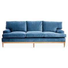 a blue couch sitting on top of a white floor