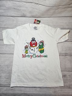 This listing is for a vintage VEGGIE TALES Christmas YOUT T-Shirt, size 6/8.  NEW With Tags from 2004.  Made with 100% pre-shrunk cotton.  It measures 14" from armpit to armpit, 12" from armpit to waist, 19" from collar to waist, and 3.75" from armpit to end of sleeve.  It's in overall good condition with the following imperfections: *A stain on the front, upper left shoulder area *Several stains on the back of the shirt Because it is a brand  new item with tags still attached, it has not been w Veggie Tales Christmas, Christmas Youth, Veggie Tales, Kids Tops, New Fashion, Overalls, Im Not Perfect, Kids Outfits, Stain