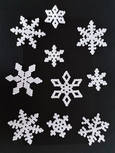 white snowflakes are arranged on a black background