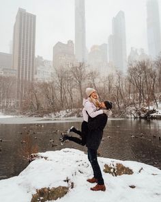 an instagram photo of a man and woman dancing in the snow near a river