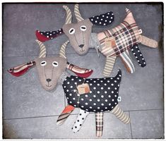 four stuffed animals laying on the ground with polka dots and plaid fabric covering them's faces