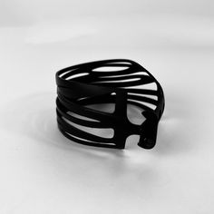 The Kaden & Kai Zebra Wrap Bicycle Tube Bracelet™ is edgy and fun all rolled into one. It looks great with just about everything. The Zebra bracelet is the perfect companion piece for a night out or an afternoon lunch with friends. This distinct cuff bracelet is rapidly becoming one of our best sellers. About Kaden & KaiEvery item in the Kaden & Kai Bicycle Tube Collection is meticulously handcrafted one at time. Our jewelry is eye-catching, lightweight, adjustable and waterproof. Kaden & Kai ma Modern Black Metal Bangle, Modern Cuff Bracelet Bangle As Fashion Accessory, Adjustable Black Cuff Bracelet For Fashion, Edgy Adjustable Bangle Bracelet, Modern Adjustable Bracelet For Fashion, Modern Adjustable Bracelet, Modern Cuff Bracelet As Fashion Accessory, Trendy Black Band Bracelets, Modern Black Cuff Bangle Bracelet