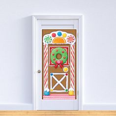 a door decorated with candy canes and a gingerbread house on the front wall