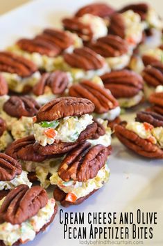 cream cheese and olive pecan appetizer bites are arranged on a white platter