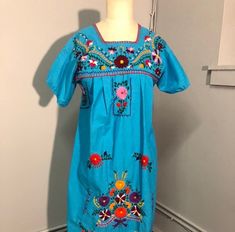 Beautifully embroidered vintage Mexican dress. Size S, mannequin measurements; Bust: 36 inches  Waist: 27 Hips: 37 Vintage Blue Embroidered Dresses, Vintage Dresses With Multicolor Embroidery For Spring, Fitted Folk Style Blue Embroidered Dress, Vintage Cotton Dress With Floral Embroidery, Vintage Short Sleeve Floral Embroidered Dress, Vintage Short Sleeve Embroidered Dress With Floral Design, Vintage Cotton Embroidered Dress With Floral Embroidery, Retro Embroidered Cotton Dress, Fitted Vintage Embroidered Dress With Floral Embroidery