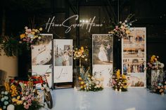 flowers and pictures on display in front of a window