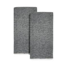 two black and white dish towels on a white background, one is folded in half