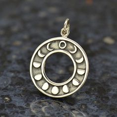 Sterling Silver Moon Phases Pendant This etched and oxidized celestial jewelry charm represents all of the lunar phases as the moon waxes and wanes. The center is a cut out circle, as if it were representing a lunar eclipse, as the different profiles of the moon form a ring around the center from New Moon to Full Moon. Each phase of the moon has its own associated meaning. New moons are for beginnings, for example, while the waning moon is believed to be a good time for banishing things, or clea Phase Of The Moon, Moon Phase Ring, Lunar Phases, Moon Phases Necklace, Necklace Moon, Celestial Necklace, Gold Bar Necklace, Lunar Eclipse, Celestial Jewelry