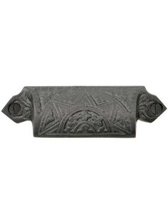 an old style door handle with ornate designs on the front and back end, in black