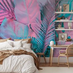 a bedroom decorated in pink, teal and blue with palm leaves on the wall