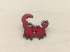 a red and black crab pin sitting on top of a table