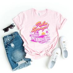 Looking for a cute versatile top to wear? Make sure to grab one of our Graphic tees! This soft and comfortable graphic tee is the perfect top for any outfit. It can be paired with biker shorts, jeans, or even a simple skirt/dress! This tee is true-to-size, so be sure to order your regular t-shirt size! If you are looking for a more oversized look, make sure to size up! Pink Graphic Print T-shirt For Loungewear, Funny Print Tops For Spring Streetwear, Spring Graphic Tee Tops, Trendy Spring Top With Front Print, Spring Letter Print Tops For Loungewear, Letter Print Tops For Spring Loungewear, Trendy Front Print Top For Spring, Trendy Tops With Front Print For Spring, Retro Letter Print T-shirt For Spring