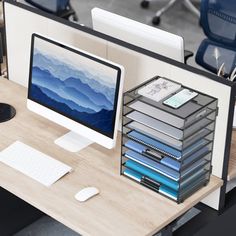 a computer monitor sitting on top of a wooden desk