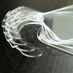 several pieces of clear plastic sitting on top of a wooden table