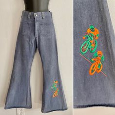 "Wonderful 1970s Jeans by Ely. With a high waist and bell bottoms, these jeans also feature a stitch detail in one of the legs of 2 Cyclists, in orange and green. It has square front and back pockets. Front snap button with the Brand Ely, as well as a front metal zipper. In good vintage condition without rips. It has a stain at the back of one of the legs, not very noticecable. Estimated size W26. Measurements: Waist 26\" Rise: 11\" Inseam 29.5\" Hips: 34\" Most of the pieces we offer are vintag Retro Green Wide Leg Jeans, Green Wide Leg Retro Jeans, Vintage Green Wide Leg Jeans, Bell Bottoms Jeans, 1970s Jeans, Green Bicycle, Bicycle Gift, Orange And Green, Retro 70s