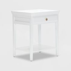 a small white table with one drawer open