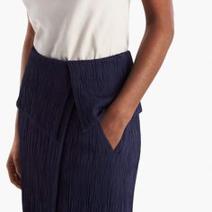 Sizing tip: This skirt runs large. Our stylists recommend ordering one size down. Inspired by classic tuxedo details, this sophisticated skirt features an angular, folded waist detail that creates a peplum-like silhouette. This season, we’ve updated it in a luxurious Italian knit with a pleated texture that allows for shaping and contouring in all the right places. Besom pockets add a little shine, while a secure underlayer keeps you feeling secured and well-covered. Fitted Pleated Skirt With Accordion Pleats For Workwear, Elegant Summer Bottoms With Accordion Pleats, Elegant Fitted Pleated Skirt For Evening, Elegant Spring Bottoms With Folds, Classic Summer Bottoms With Accordion Pleats, Modern Structured Bottoms For Formal Occasions, Party Skirt With Folds, Chic Stretch Skirt With Folds, Modern Structured Formal Bottoms