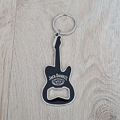 a black guitar shaped keychain with the name markdown's on it