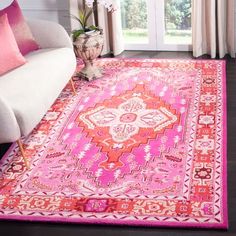 a pink and orange rug in a living room