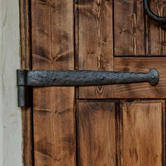 an old metal handle on a wooden door