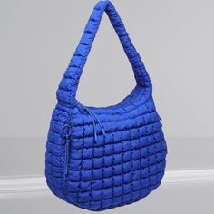 This Celeste Hobo Bag will be your go-to for every occasion. With its puffy, quilted design and attention to detail, it's the perfect balance of chic and functional. Whether you're dressing up or down, its versatility will keep you looking fashionable all the time! Trendy Nylon Puffer Bag, Trendy Everyday Puffer Bags, Trendy Puffer Bag, Travel Nylon Puffer Shoulder Bag, Chic Blue Quilted Bag, Versatile Quilted Shoulder Bag For On-the-go, Functional Quilted Shoulder Bag For On-the-go, Blue Quilted Nylon Bags, Chic Blue Quilted Shoulder Bag