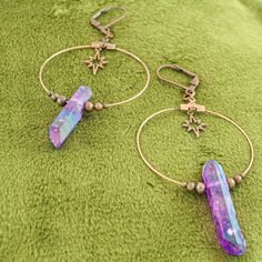 These iridescent purple quartz crystal earrings are the perfect celestial gift idea. Each antique copper hoop earring has a genuine stone hanging beneath an art deco starburst charm and surrounded by dainty copper beads. These earrings are a bold conversation starter. They are a bit heavy due to the fact that these are real quartz crystals, but the ultra light hoop and charms help offset the weight. A gorgeous oddity jewelry set. -Genuine iridescent purple quartz crystals -Art deco starburst cha Iridescent Pierced Drop Earrings, Celestial Star Jewelry For Festival, Celestial Star-shaped Festival Jewelry, Celestial Festival Star Jewelry, Mystical Ear Wire For Jewelry Making, Mystical Style Ear Wire For Jewelry Making, Iridescent Adjustable Mystical Jewelry, Celestial Style Drop Earrings For Festivals, Bohemian Iridescent Jewelry With Ear Wire